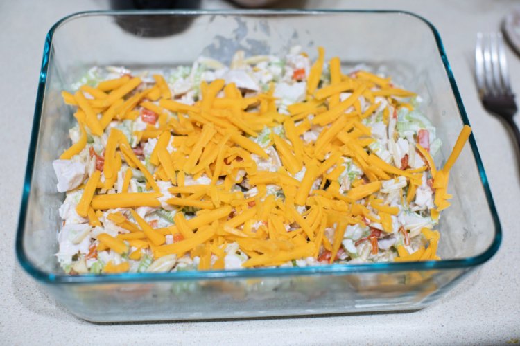 This Hot Chicken Salad is a recipe that is near and dear to my heart. I've been eating this since I was a little girl and it still makes me smile to this day. It's one of my favorite summer sandwich recipes that I can sit out on the porch and enjoy. Any type of salads seem to be a favorite for all. Pin it for later. This recipe has actually been in my family for years and I'm so happy to be sharing it with all of you. My Aunt Mega introduced this to me for the first time and this was her go-to dish for an outdoor event with friends. I still remember the shock of how good it was. Like, really really good. This is why it's delicious and on my mind, always. Now that the weather is warming up a bit, I've added this simple chicken recipe to a frequent rotation in my meal planning.  Hot Chicken Salad - Not Just For Picnics or Lunch This dish was always a hit because it's unique. Most lunch salads are cold that we know about, right? Like this  Easy Cucumber and Tomato Salad or this Roasted Golden Beet and Goat Cheese Salad. But this recipe is served hot. And it's delicious.  I like to actually make this up the night before and let the flavors simmer a bit overnight. But it's just as delicious to cook it up and eat it right then and there, too.  What is the fastest way to cook chicken? In my opinion, boiling the chicken for this dish is super fast. I like to do that as it's an easy way to cook the chicken entirely before cutting it up for this dish. And since a lot of the flavors come from the other added ingredients, I don't really have to worry about seasoning the chicken before cooking it.  At what internal temperature is chicken cooked all the way? For the chicken to be considered a safe temperature to eat, it needs to be at 165 degrees. The easiest way to know the internal temperature is to use a meat thermometer and check. Make certain that you test in the middle of the meat so that you're getting an accurate reading.  Ingredients needed to make Chicken Salad with Almonds 3 cups diced chicken ½ cup chicken broth 1 cup slivered or sliced almonds 1 small jar of pimento strips 2 cups chopped celery 1 tablespoon lemon juice 1 tablespoon minced onion 1 ½ cup mayonnaise 1 teaspoon salt 1 cup crushed plain potato chips ½ cup grated mild cheddar cheese How to make Hot Chicken Salad This salad recipe is fast and easy to make! Once you cook up the chicken, the rest is a breeze. Boil chicken breasts until done. Let cool.  Dice into 1/2" cubes. Combine all ingredients in a medium bowl, except cheese and chips. Pour this into a greased 9 x 13 casserole dish. Sprinkle the cheese on top, then the chips. Bake at 350 for 20 – 25 minutes, just until hot all the way through. How do you eat hot chicken salad? There are actually a few different ways that you can serve up this dish. I like to eat it between two toasted pieces of bread but it's also great to eat with crackers or even pita bread. It can be like a dip as well so this gives so many options to enjoy.  How to store leftover chicken salad Make certain to store this in the fridge with a lid. That way you can reheat and enjoy it later down the road as well. This simple salad recipe is addictive, so be ready!  More Delicious Salad Recipes Strawberry Pretzel Salad Recipe, A Southern Tradition Simple As Can Be Taco Bar Corn Salad The Perfect Loaded Potato Salad Recipe
