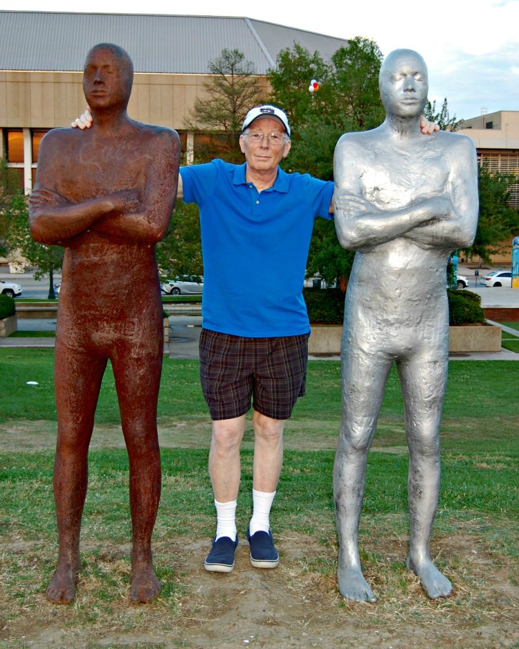 Don Palmer with the statues at Baton Rouge Louisiana. You can tell how tall they are.