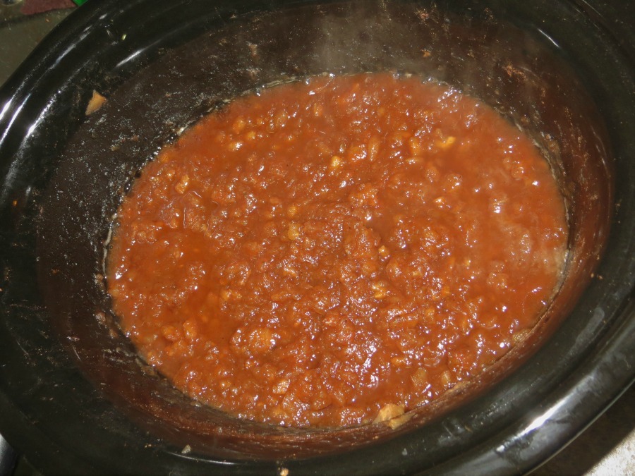 adding apples to the crock pot 