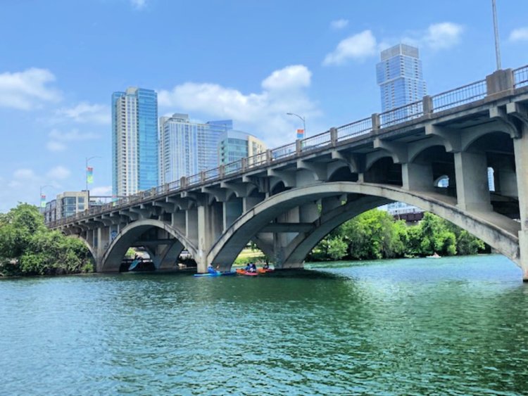 favorite-things-in-austin-my-home-and-travels-lady-bird-lake-capital-cruises-boat going under a bridge