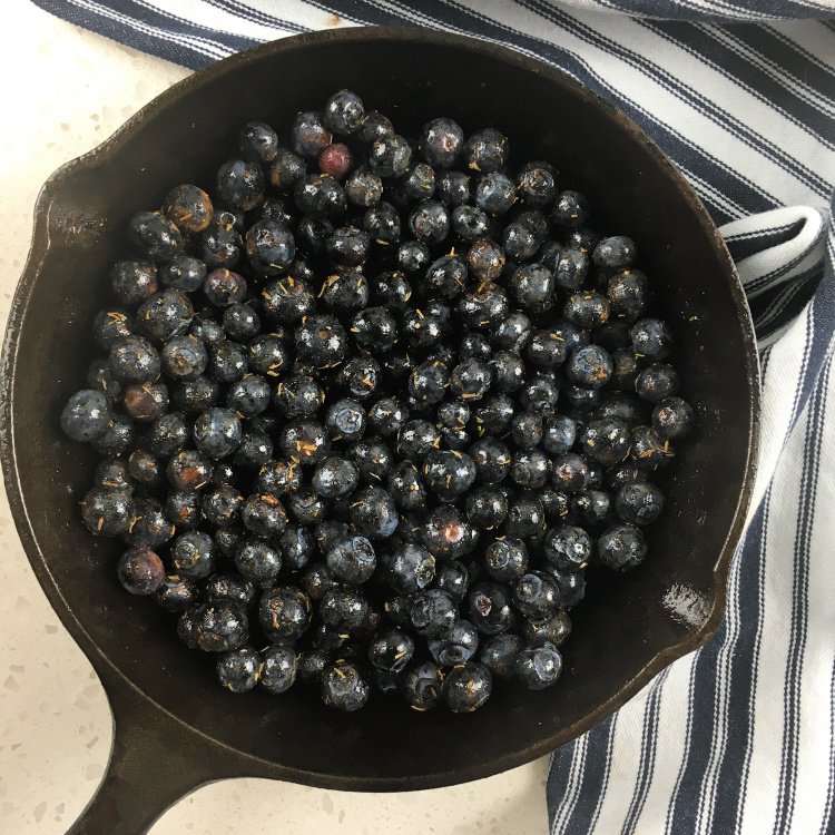 Simple Blueberry Crisp with Maple Syrup my home and travels image blueberry mixture poured into skillet layered