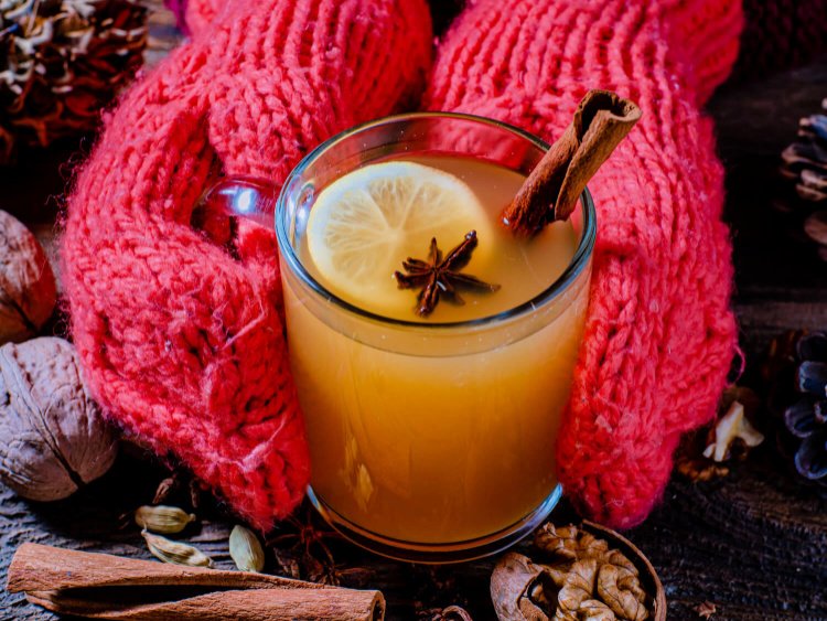 mulled white wine recipe my home and travels served in glass with gloves