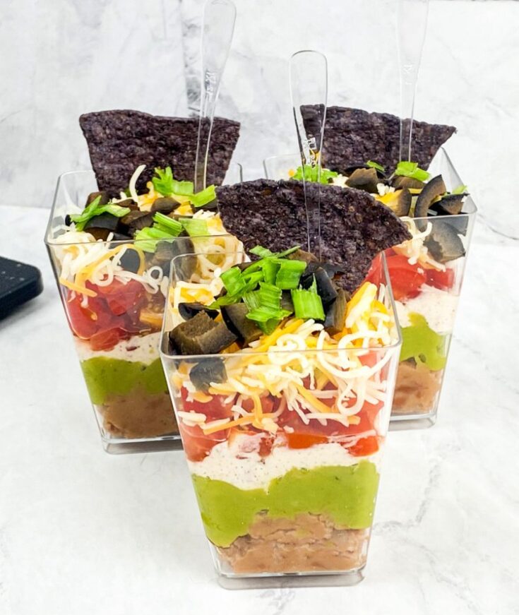 easy-7-layer-dip-for-appetizer-my-home-and-travels-dip-in-cups-marble-background.